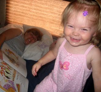 A big smile as Mommy reads a book before nap in the RV
